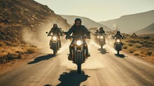 A Group Of People Riding Motorcycles On A Dirt Road