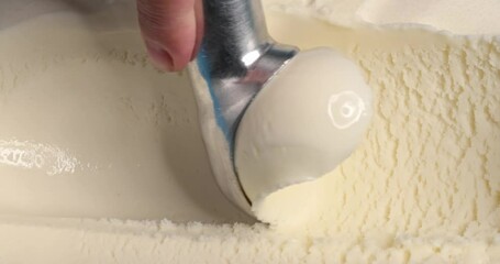 Poster - Vanilla ice cream scooping out of container by metal spoon