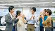 拍手するオフィスカジュアルを着た笑顔のビジネスグループ