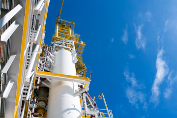 Close up view of industry at oil refinery plant as industrial field with sunlight and sky.