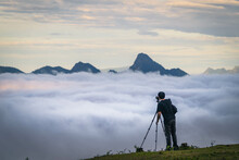 A Man With Tripod Taking A Photo In The Mountain Summit With Sea Of Cloud, Fantastic Sky And Sunrise (Tak Province, Thailand)