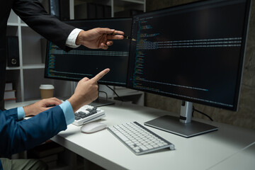 IT programmer working on desktop computer Male expert innovating software engineer app development program check coding in bugging system.