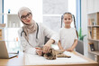 © sofiko14 - Vet with syringe and tween girl posing near cat on table