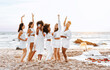 © Prostock-studio - Hen party picnic. Young diverse ladies with glasses of wine dancing standing on the beach in the evening