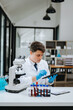 © Nuttapong punna - Modern medical research laboratory. female scientist working with micro pipettes analyzing biochemical samples, advanced science chemical laboratory .