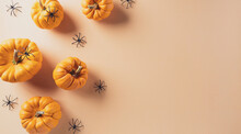 Halloween Decorations Made From Pumpkin And Black Spider On Pastel Orange Background. Flat Lay, Top View With Copy Space For Text.