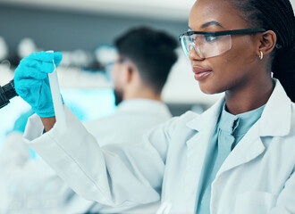 Canvas Print - Science, research and black woman with test tube in laboratory, results and medical engineer. Biotechnology, pharmaceutical study and vaccine, scientist or lab technician checking solution in glass.