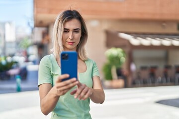 Canvas Print - Young woman smiling confident making selfie by the smartphone at street