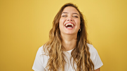 Wall Mural - Young beautiful hispanic woman laughing a lot standing over isolated yellow background