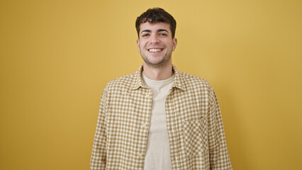 Poster - Young hispanic man smiling confident over isolated yellow background