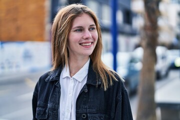 Sticker - Young blonde woman smiling confident looking to the side at street