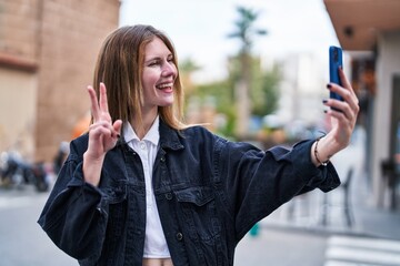 Sticker - Young blonde woman smiling confident making selfie by the smartphone at street