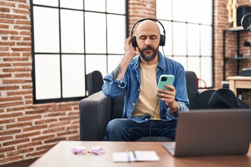 Sticker - Young bald man musician listening to music at music studio