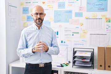 Canvas Print - Young bald man business worker standing with serious expression at office