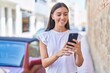 © Krakenimages.com - Young beautiful hispanic woman smiling confident using smartphone at street