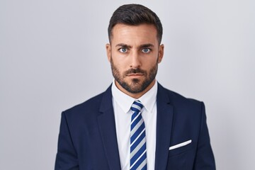 Sticker - Handsome hispanic man wearing suit and tie skeptic and nervous, frowning upset because of problem. negative person.