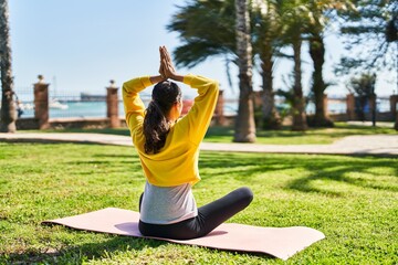 Wall Mural - Young african american woman training yoga exercise at park