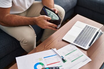 Sticker - Young hispanic man using laptop accounting at home