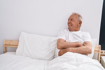 Canvas Print - Senior grey-haired man smiling confident sitting on bed at bedroom