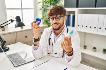 Canvas Print - Young arab man wearing doctor uniform choosing respiratory treatment at clinic