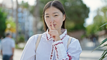 Sticker - Young chinese woman doing silent gesture at park