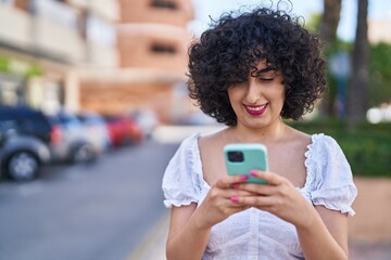 Canvas Print - Young middle east woman smiling confident using smartphone at park