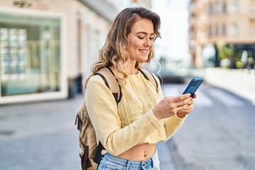 Sticker - Young woman tourist smiling confident using smartphone at street