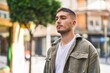 © Krakenimages.com - Young hispanic man with relaxed expression standing at street