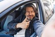 © Krakenimages.com - Middle age man make selfie by camera doing ok gesture at street