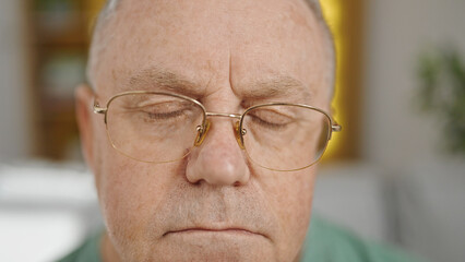 Sticker - Middle age grey-haired man sitting on sofa with relaxed expression at home