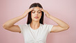 © Krakenimages.com - Young caucasian woman suffering for headache over isolated pink background