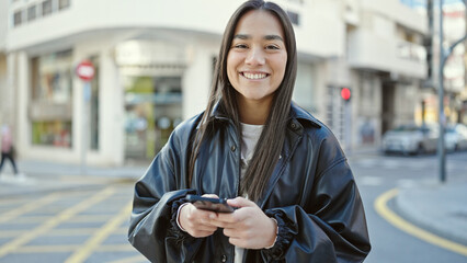 Poster - Young beautiful hispanic woman smiling confident using smartphone at street