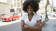 © Krakenimages.com - African american woman smiling confident standing with arms crossed gesture at street