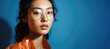 Close-up beauty portrait of a young asian woman model wearing glasses on a blue backdrop