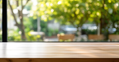 Wall Mural - Empty wooden table is set with simple tableware and blurred large windows, a majestic tree natural background. High quality photo