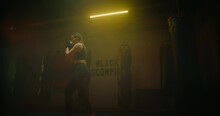 Good-looking Sportive Woman Training Alone In Gym, Fighting And Punching Air, 4K, Prores