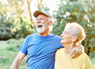 Wall Mural - outdoor senior fitness woman man lifestyle active sport exercise healthy fit couple running jogging elderly mature having fun water bottle talking together friend hug break