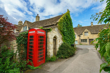 Sticker - Red telephone box in Castle Combe village in Cotswold. United Kingdom