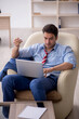© Elnur - Young male employee sitting in the office