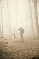 Poster - happy dog and owner in foggy forest