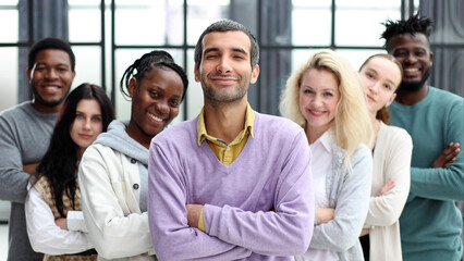 Wall Mural - Group of business people standing at the window of a modern office