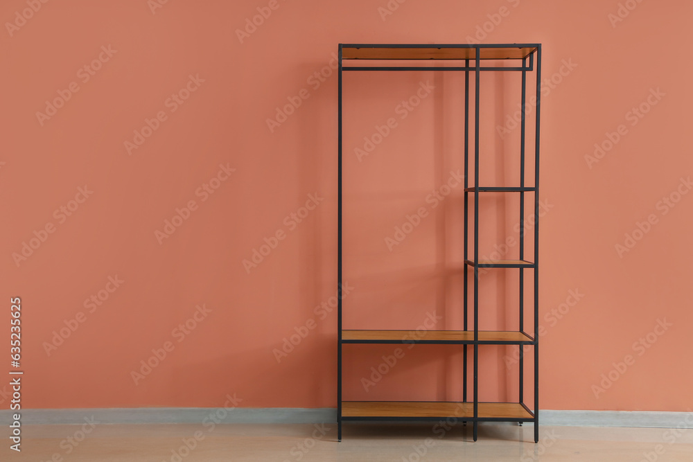 Empty shelving unit near pink wall in room