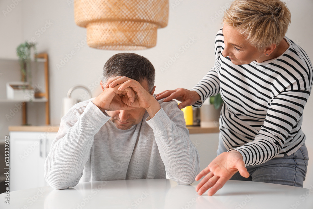 Mature couple quarreling in kitchen