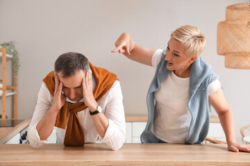 Wall Mural - Mature woman quarreling with her husband in kitchen