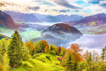 Wall Mural - outstanding autumn view on suburb of stansstad city and lucerne lake with mountaines and fog.