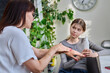 © Valerii Honcharuk - Mother telling showing skin care products to preteen daughter.