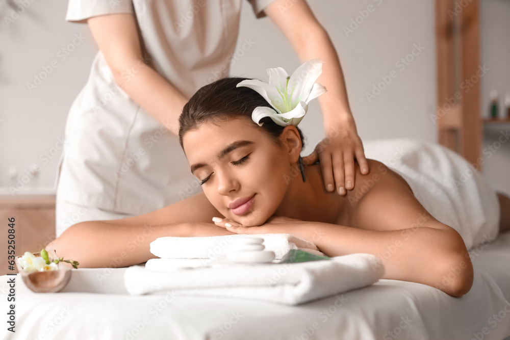 Beautiful woman receiving spa massage in salon