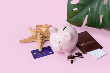 Sticker - Piggy bank with beach accessories, credit card and passport on pink background. Concept of savings for travel