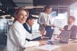 © Yaroslav Astakhov - businesswoman sitting at the office table with group of colleagues, working on laptop.