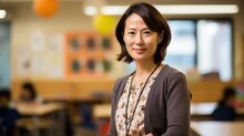 A Photo Portrait Of A Beautiful Adult Asian School Teacher Standing In The Classroom. Students Sitting And Walking In The Break. Blurry Background Behind. Generative AI